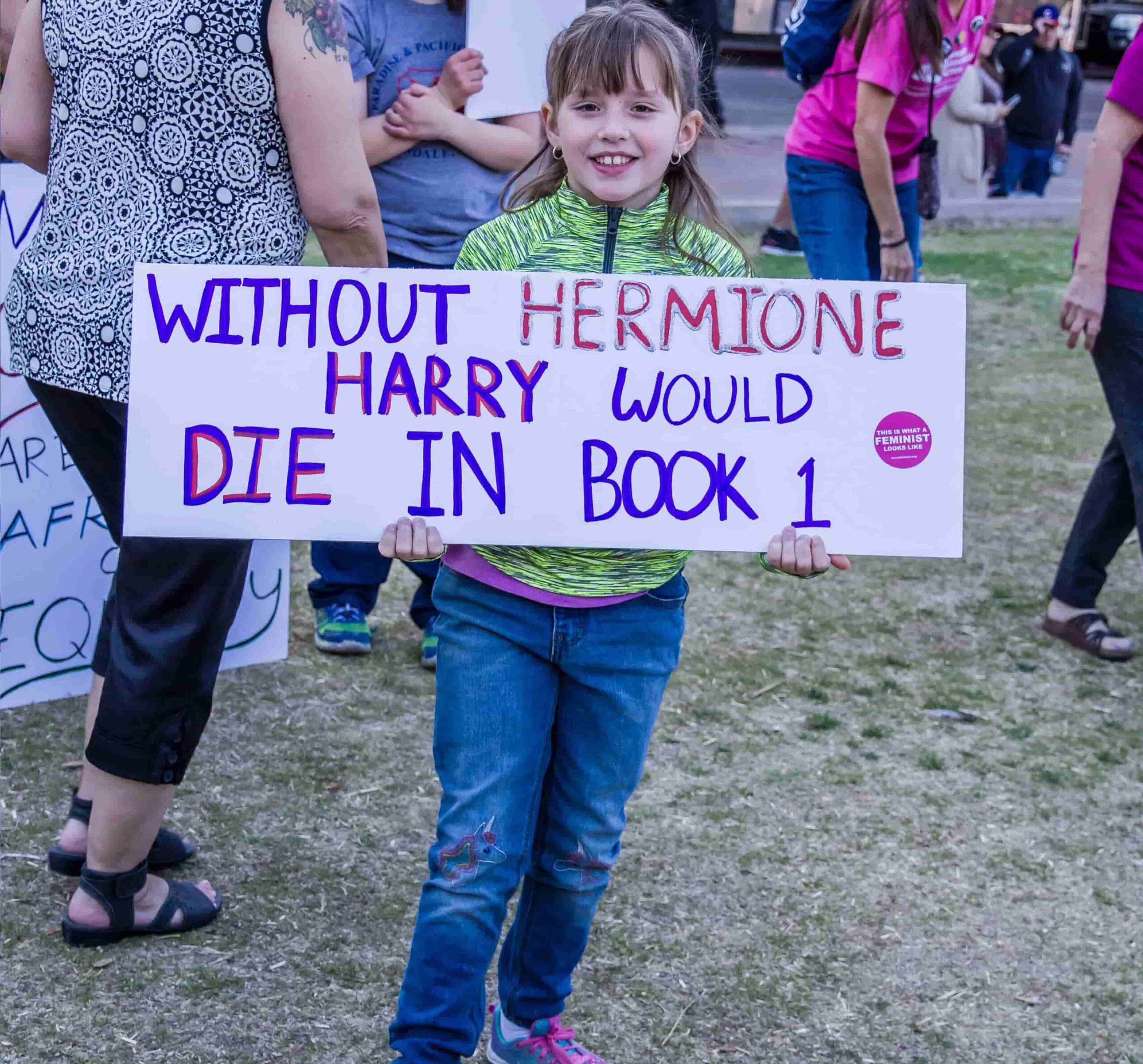 Girl proudly displays a placard stating: 